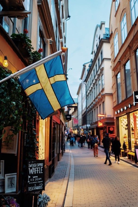 a narrow street with a sign that says waffle on it